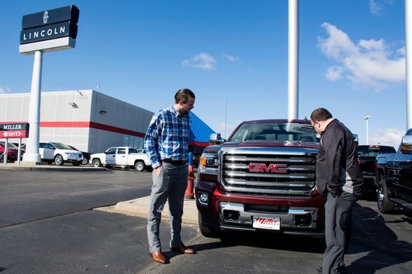 Miller Auto & Marine, Showing a GMC Truck to a Potential Buyer