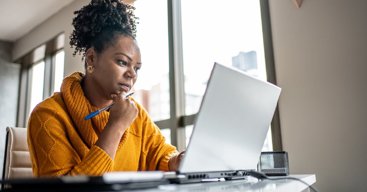 A woman working on a laptop.